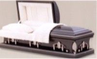a black casket with the lid open and a white blanket on it .