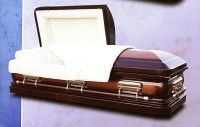 a casket with the lid open is sitting on a purple surface .