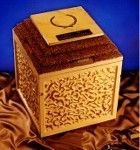 a wooden urn vault is sitting on top of a brown cloth on a table .