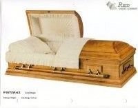 a wooden casket with the lid open and a white blanket on it .