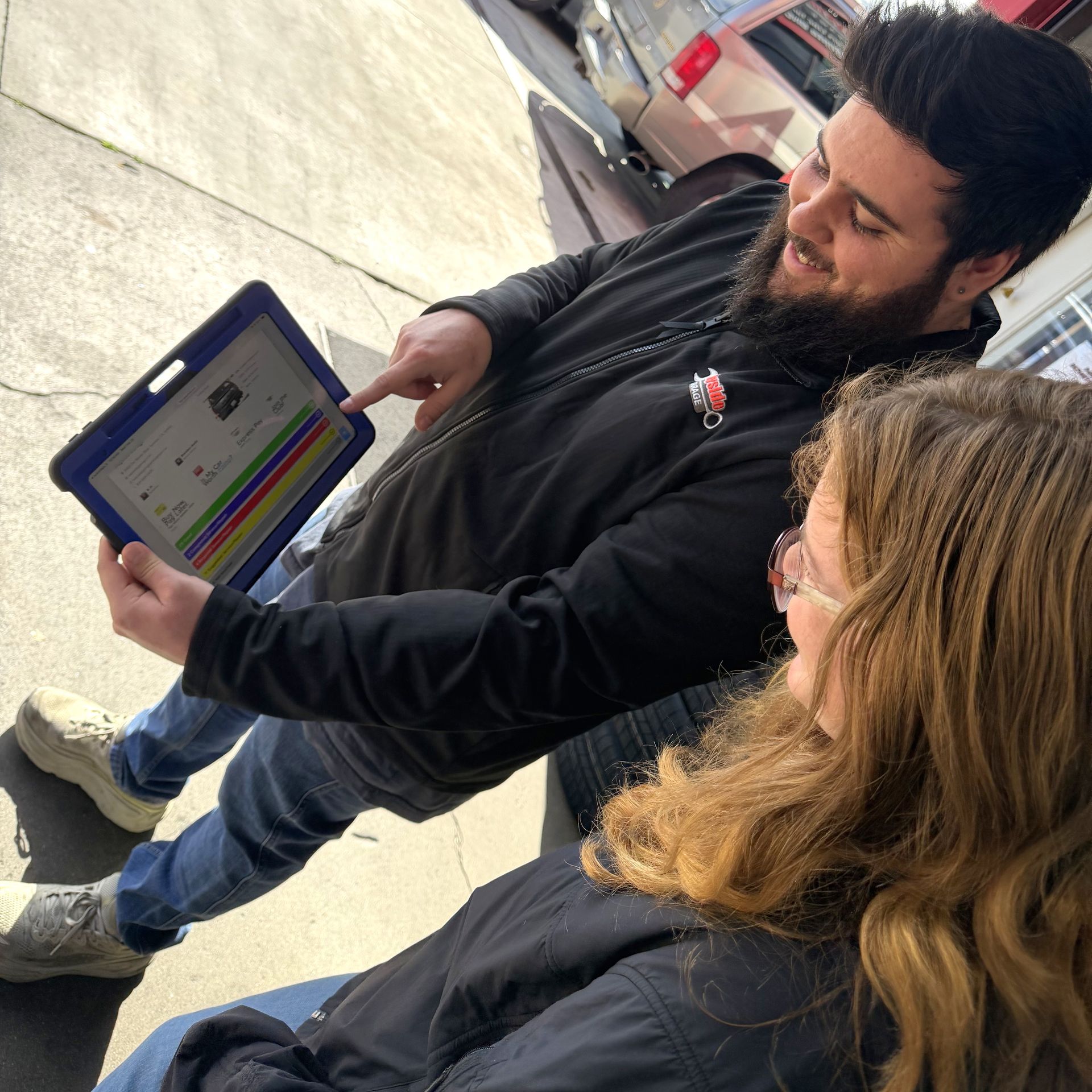 Service advisor explaining auto repair options to customer at Wayside Garage in Seaside CA