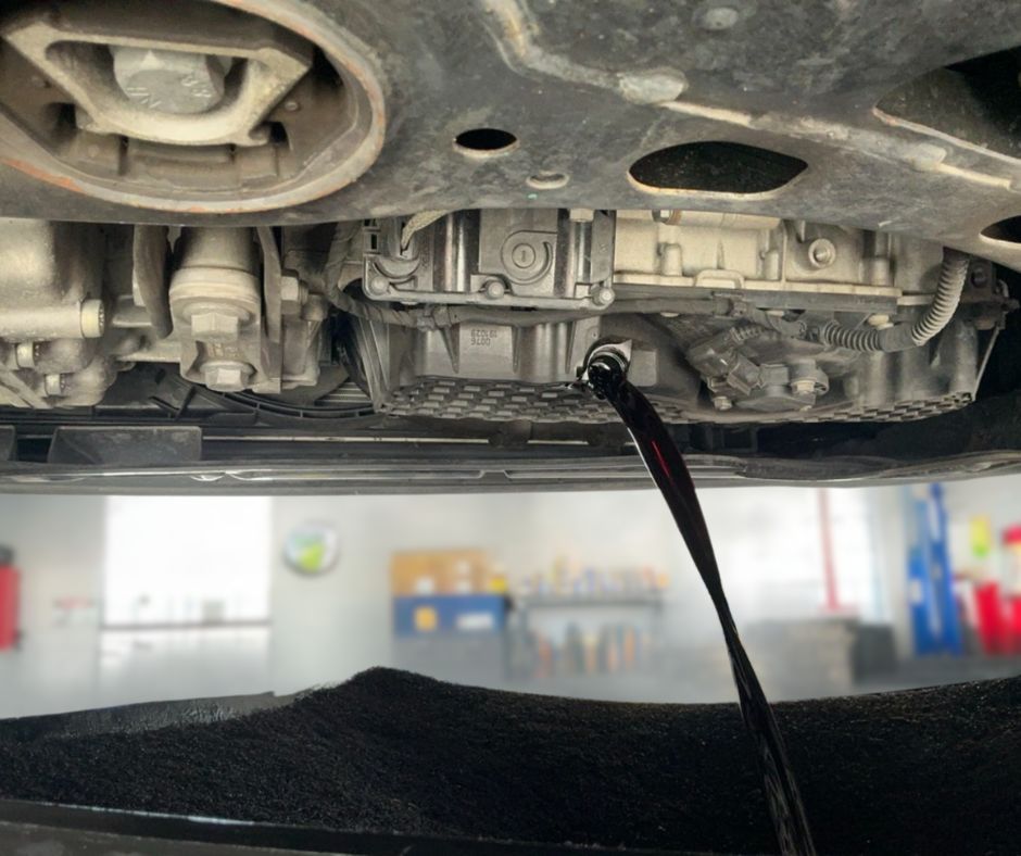 Engine oil draining during oil change service at Wayside Garage in Seaside CA