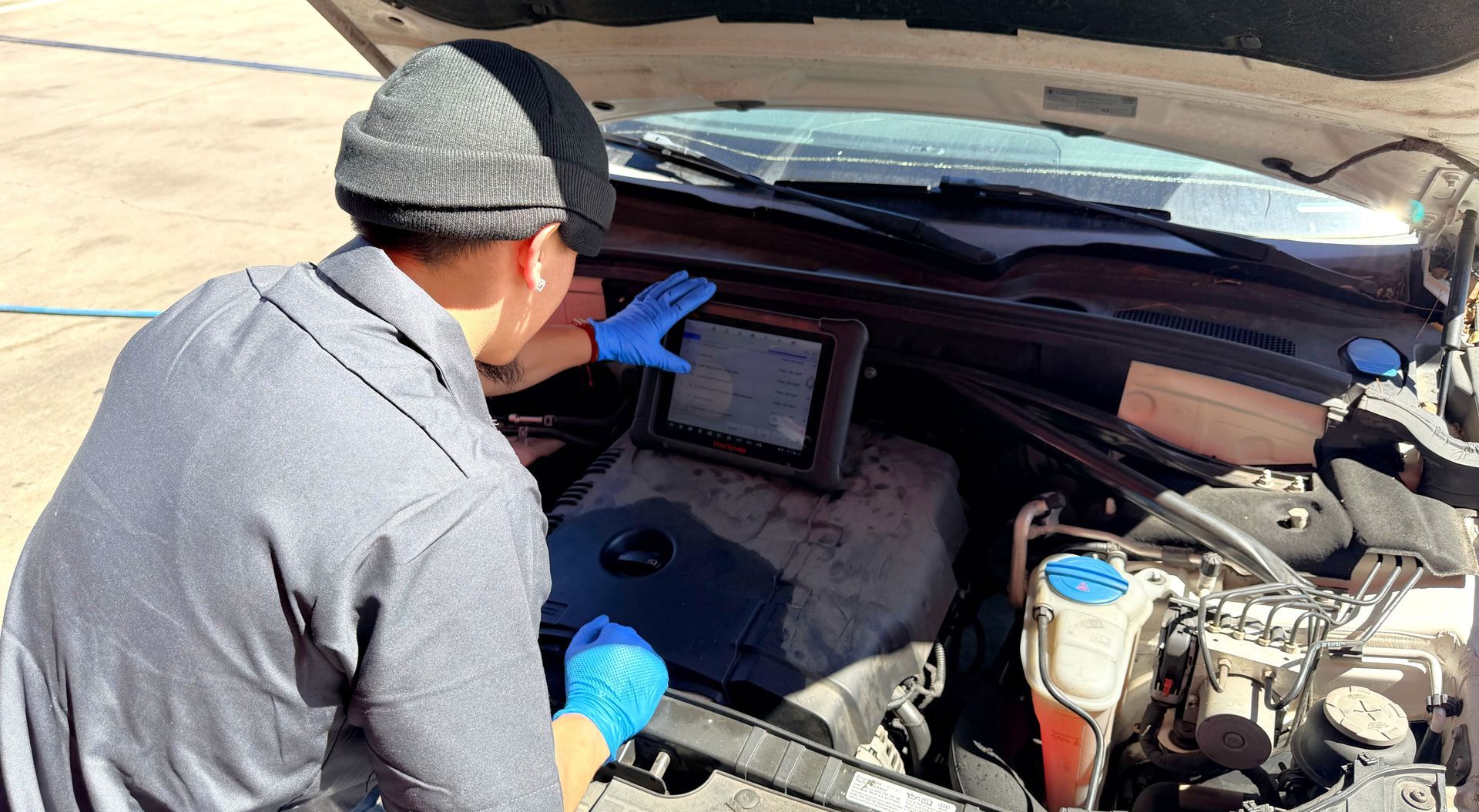 Technician performing check engine light diagnostic using scan tool at Wayside Garage in Seaside CA