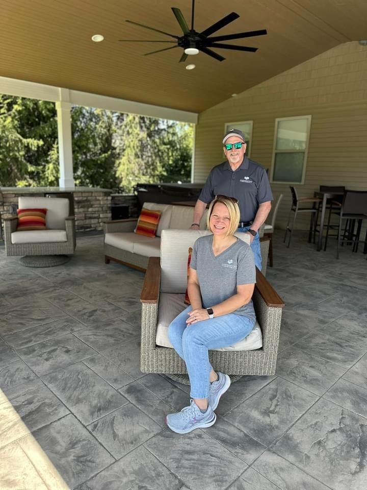 A man and a woman are standing next to each other in a room.