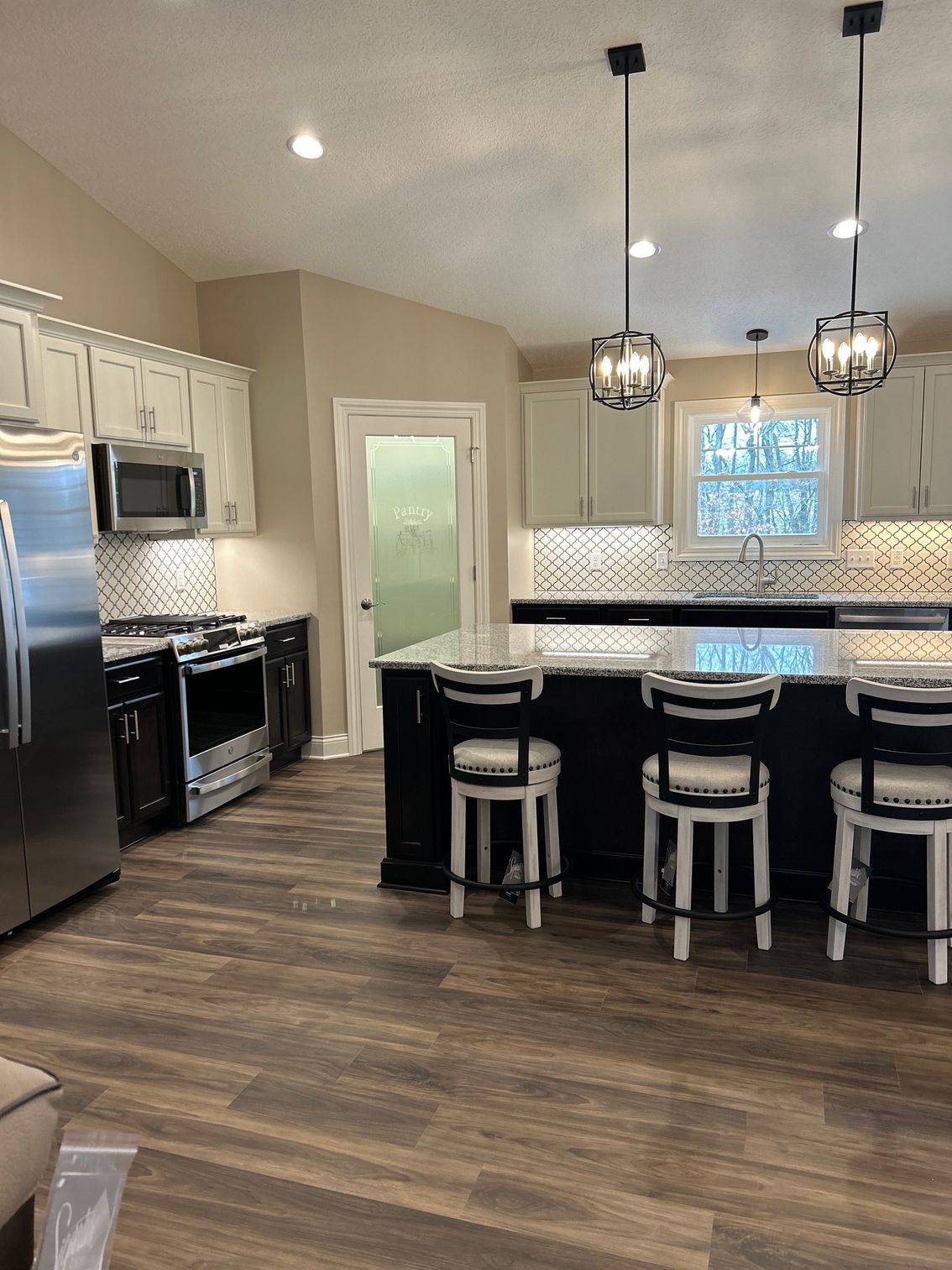 A kitchen with stainless steel appliances and a large island.