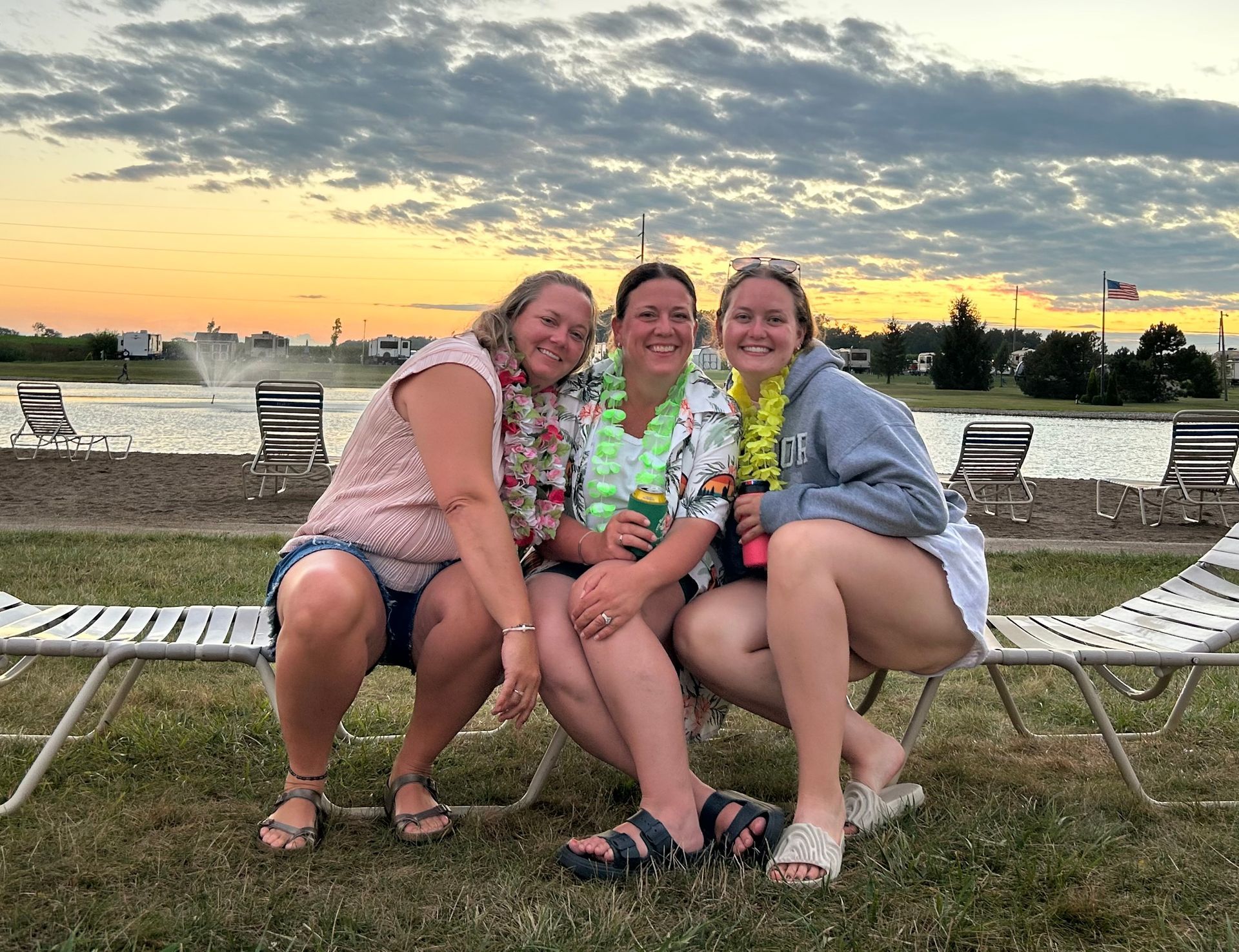 Three women are posing for a picture while sitting on lawn chairs. | Chickasaw Garage
