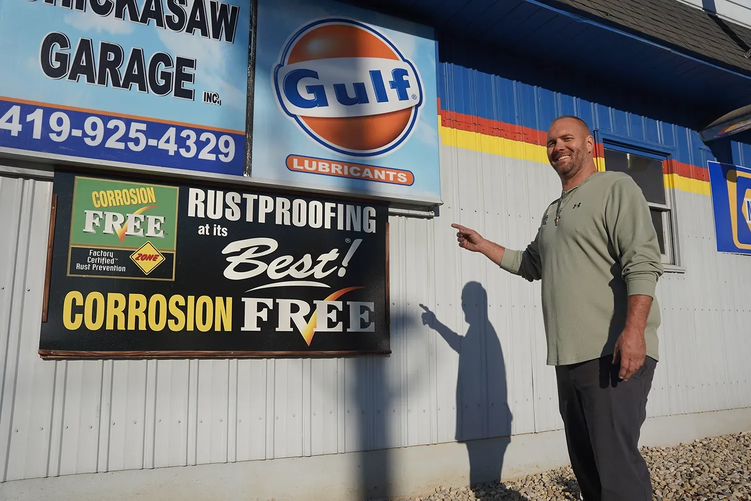 Staff pointing at outside of our shop | Chickasaw Garage