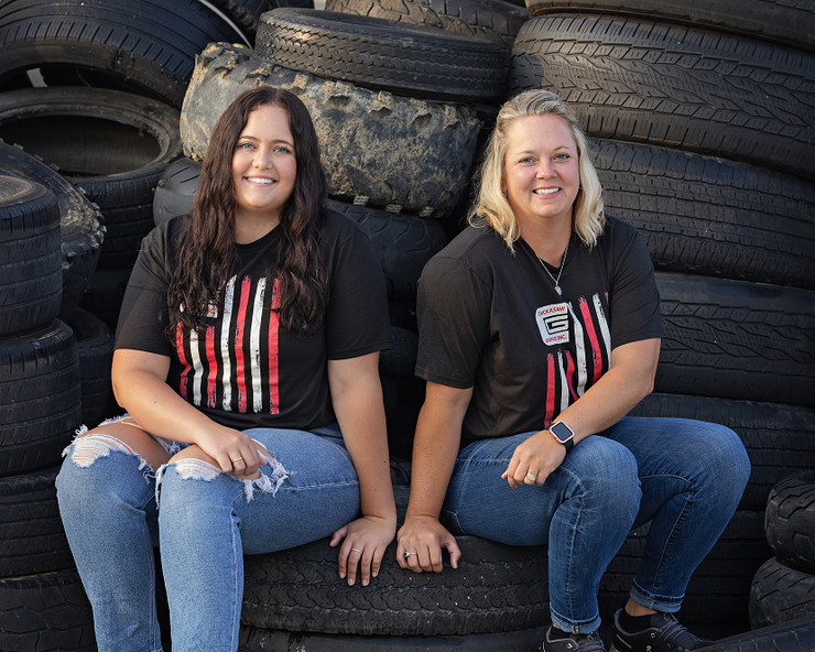 Two People Sitting on a Tire | Chickasaw Garage