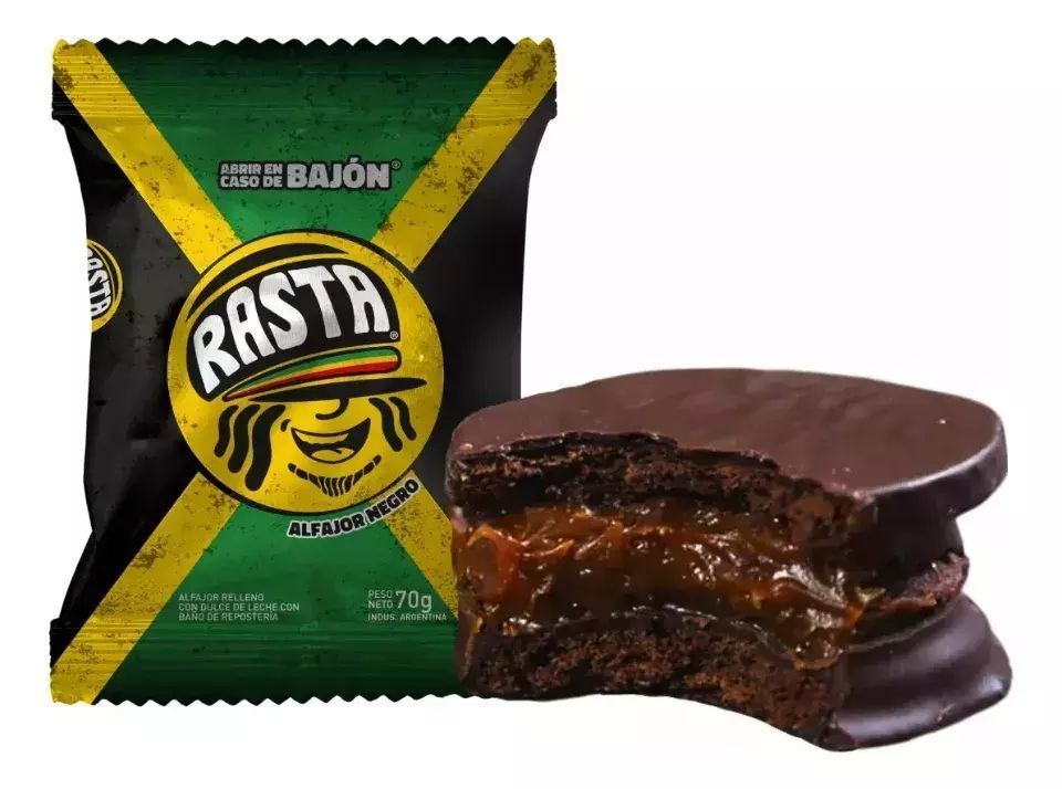 Paquete de alfajor rasta con los colores de la bandera de Jamaica, y un alfajor mordido con relleno de caramelo.