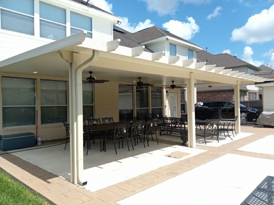 A patio with a table and chairs under a large patio cover in Lago Vista, TX.