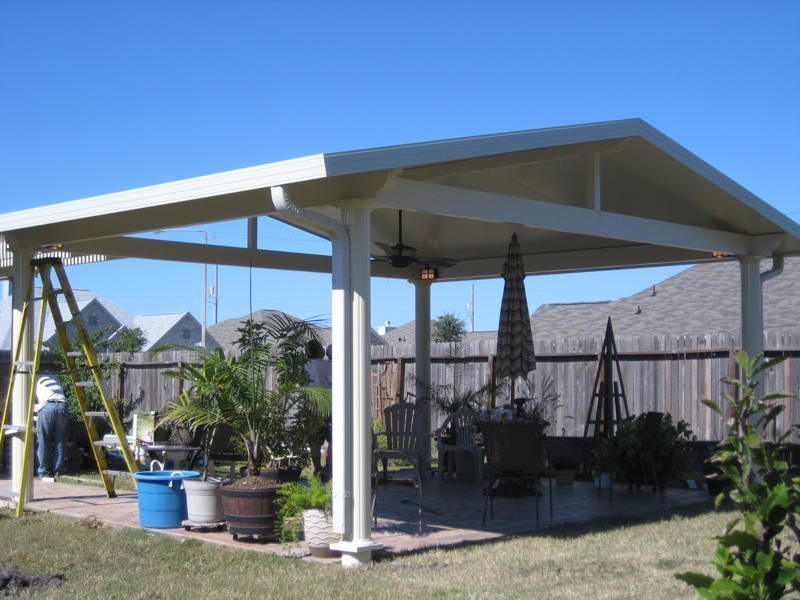 A patio with a white roof and a ladder in New Braunfels, TX.