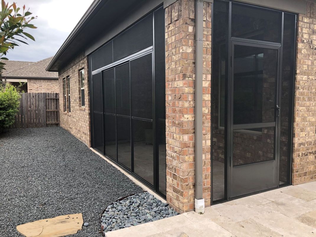 A Houston home with a new patio cover and a full screen enclosure.