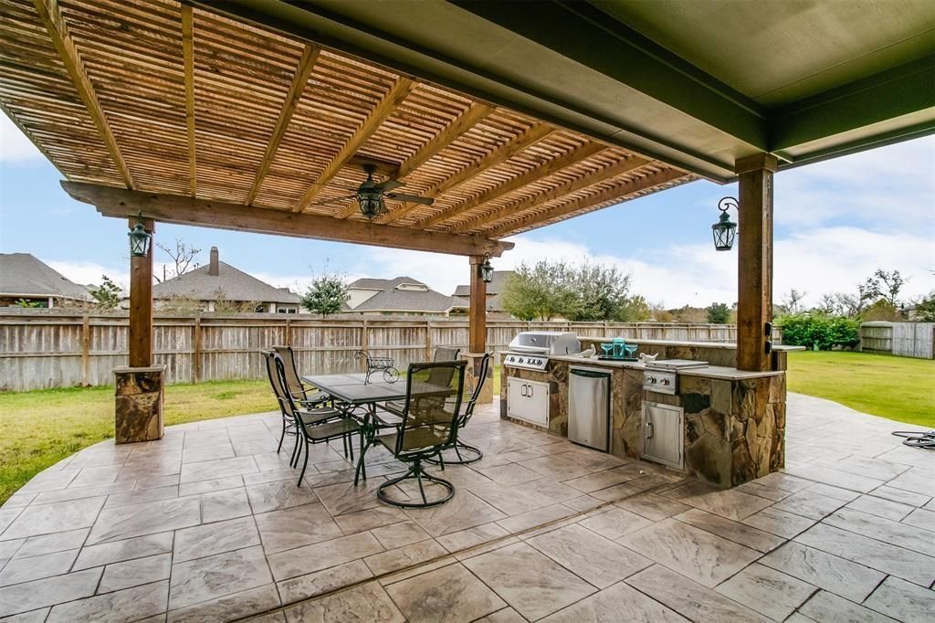 Backyard patio cover in Rosenberg TX with roof and wood beams