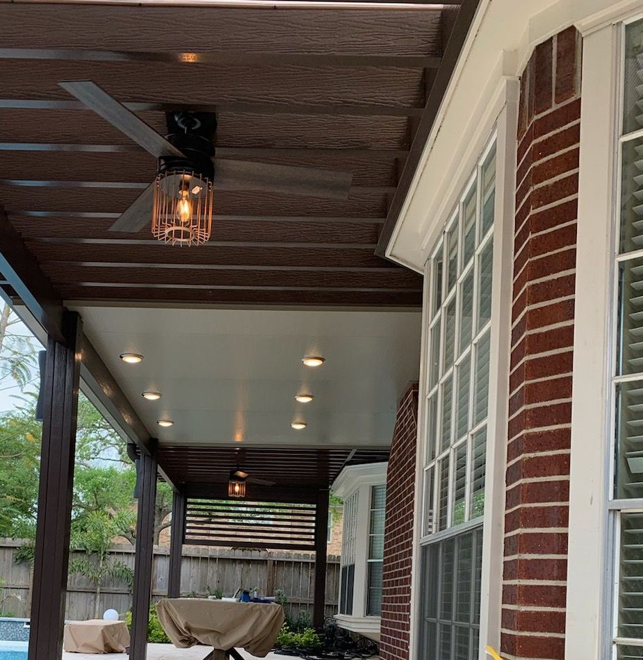 A brick house with a covered pergola  in Manor, TX.