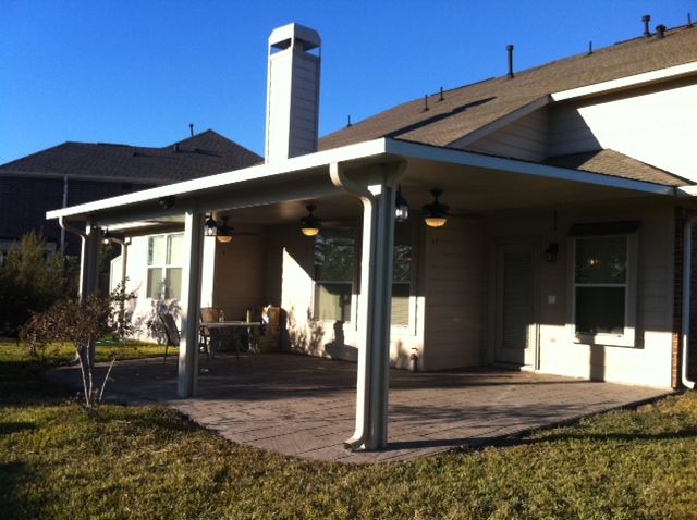 A house with a patio shade cover and a chimney on the roof in Austin, TX.