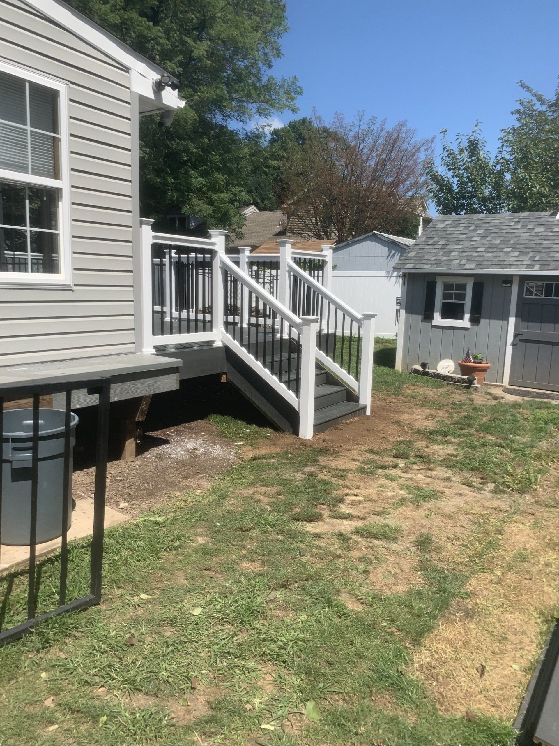 another view of new deck with stairs off the side yard
