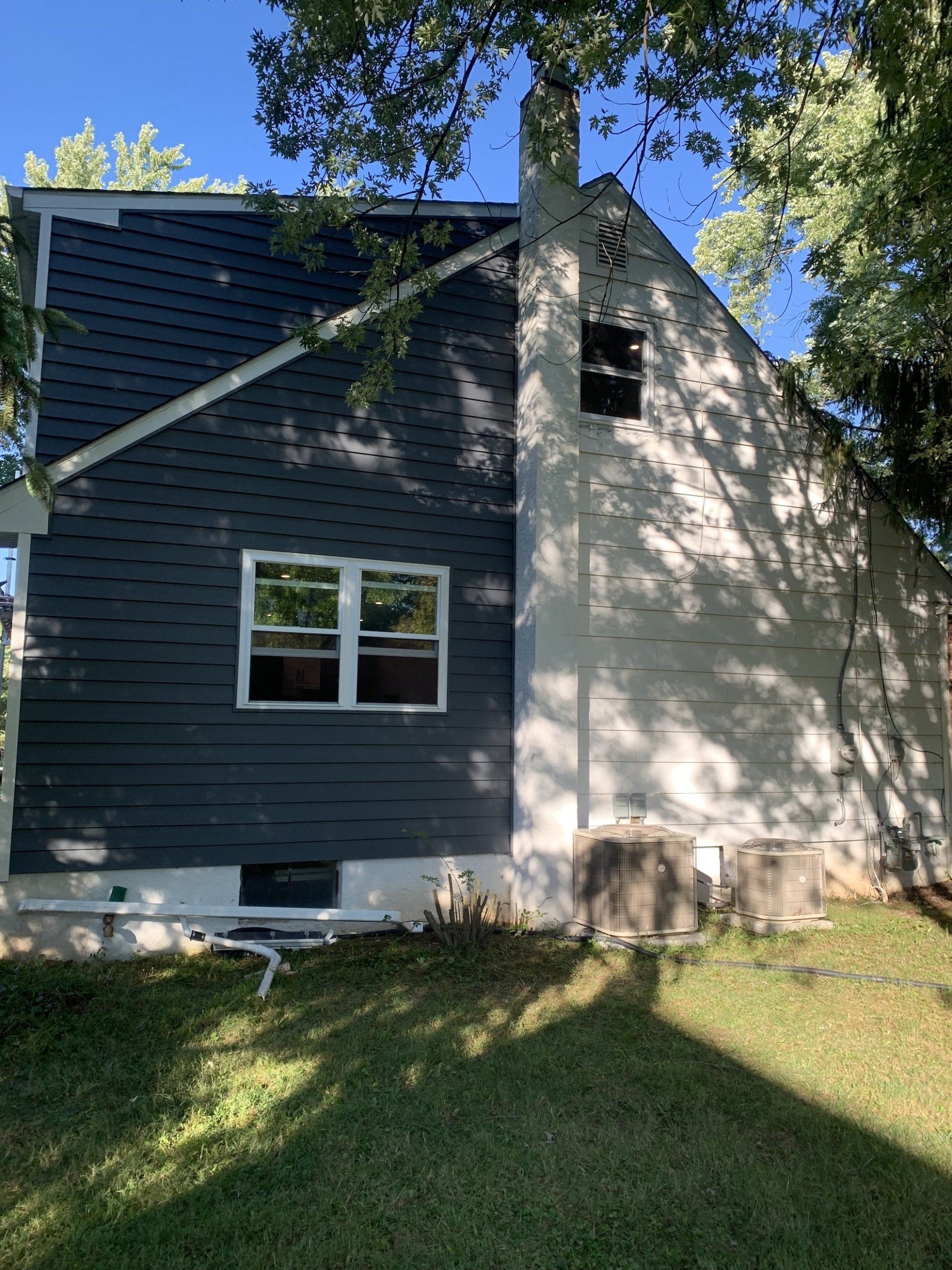 exterior home in progress of being painted dark gray