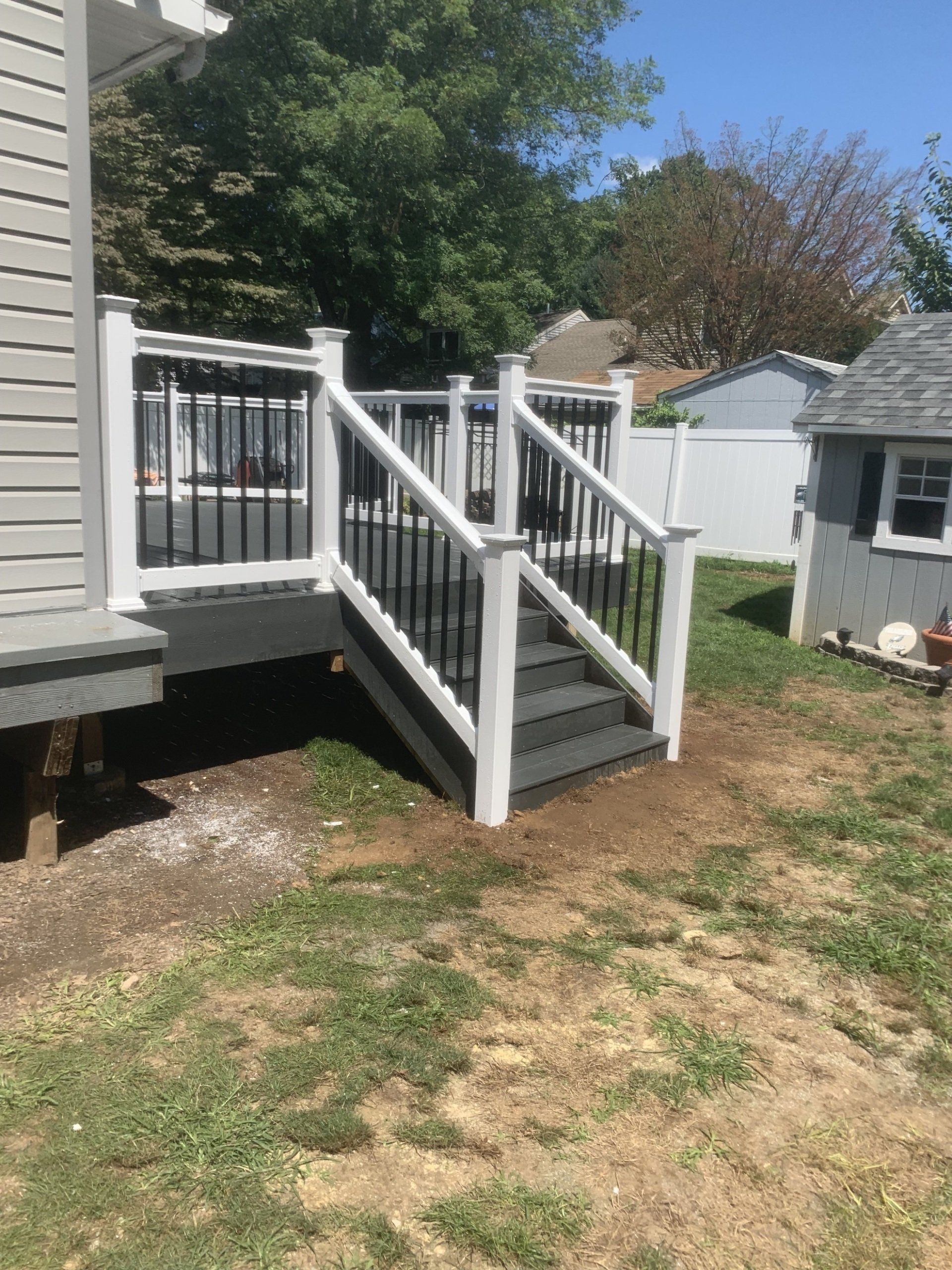 new deck with stairs off the side yard