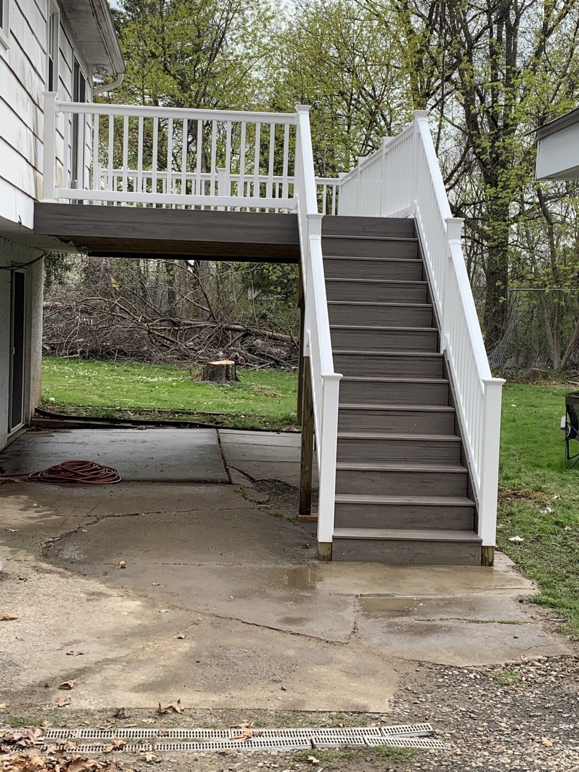view of new stairs for elevated wood deck overlooking backyard