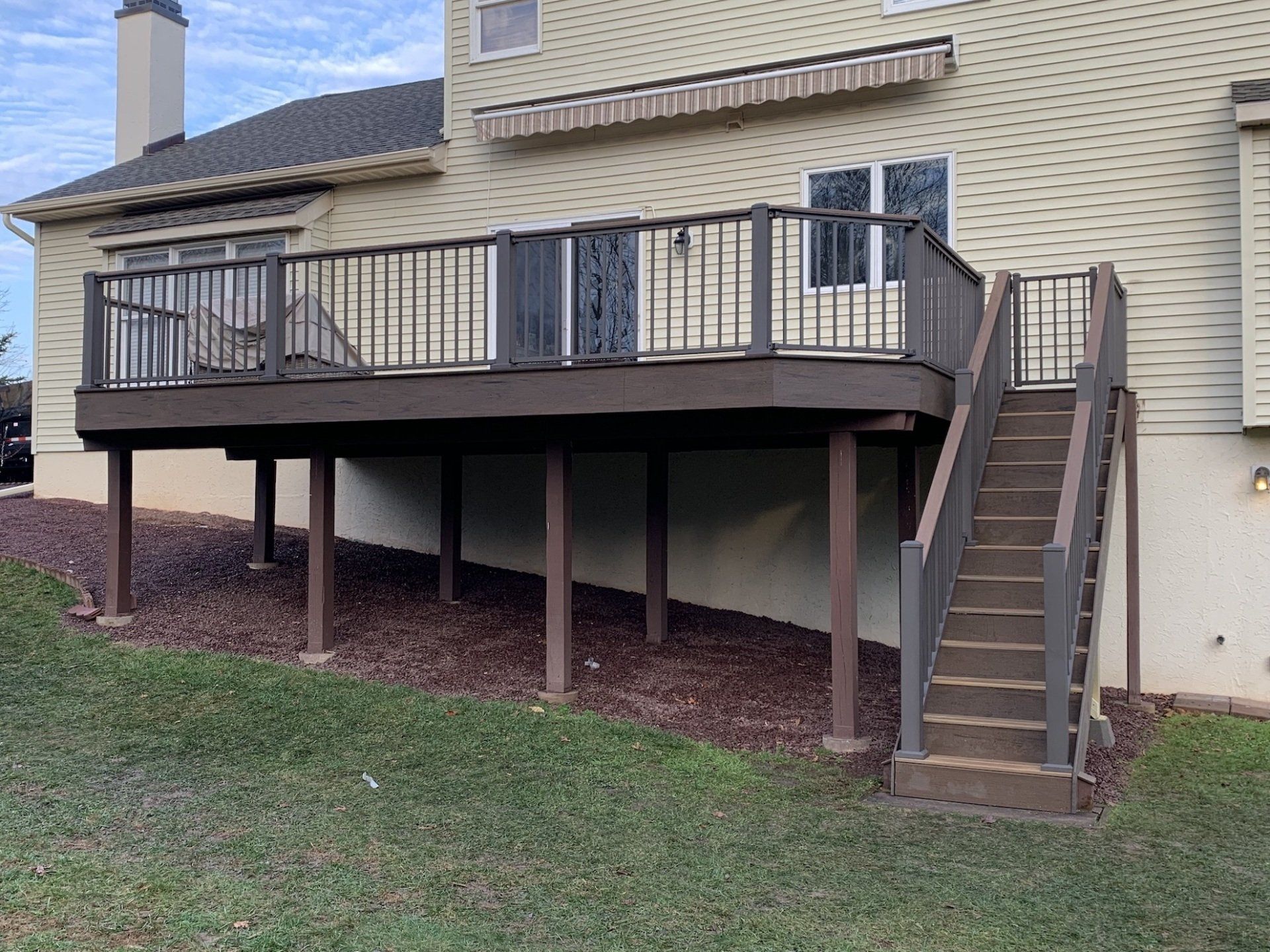 new 2nd level deck installation with posts backyard view