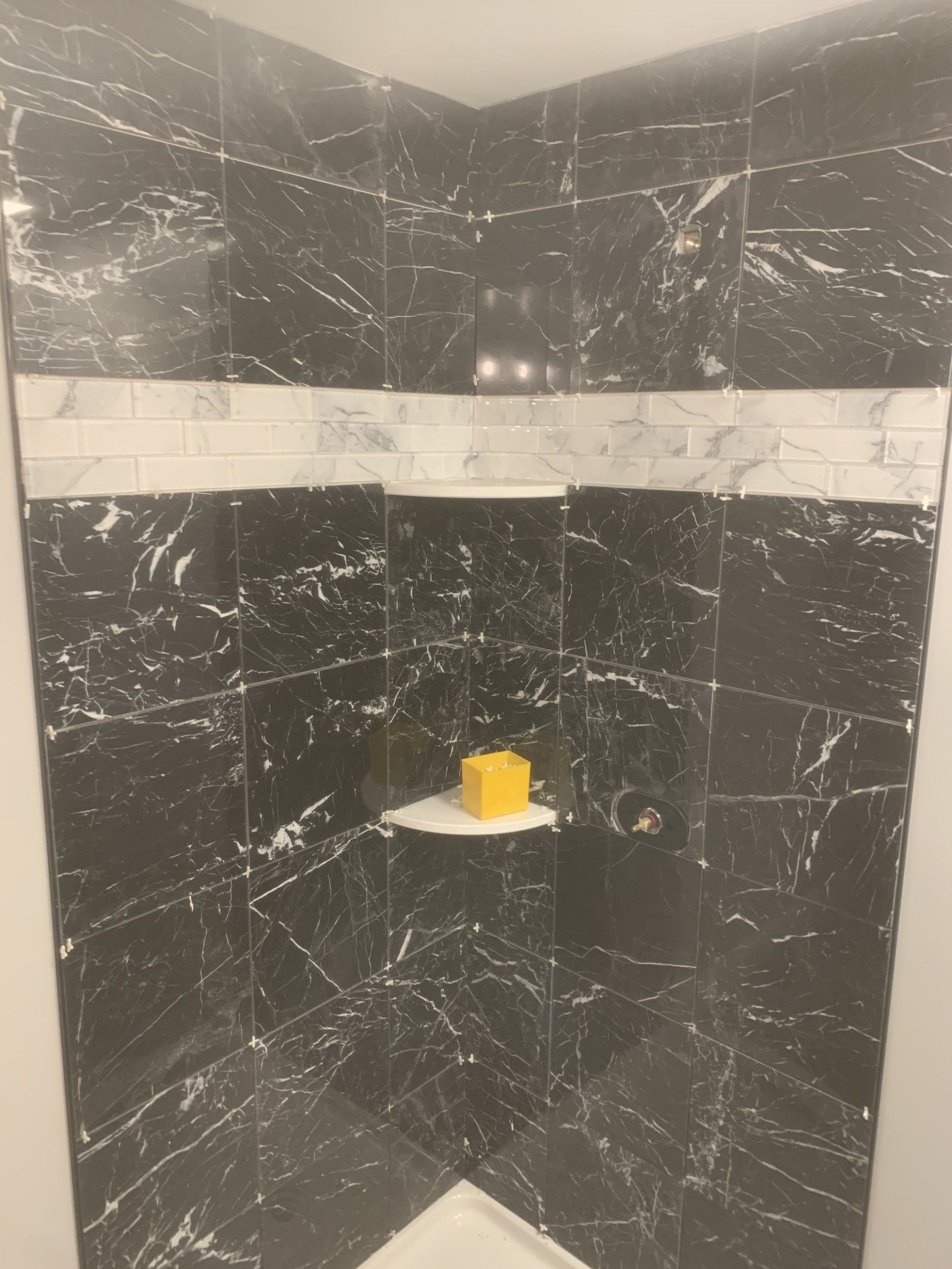 tile installation in corner shower enclosure