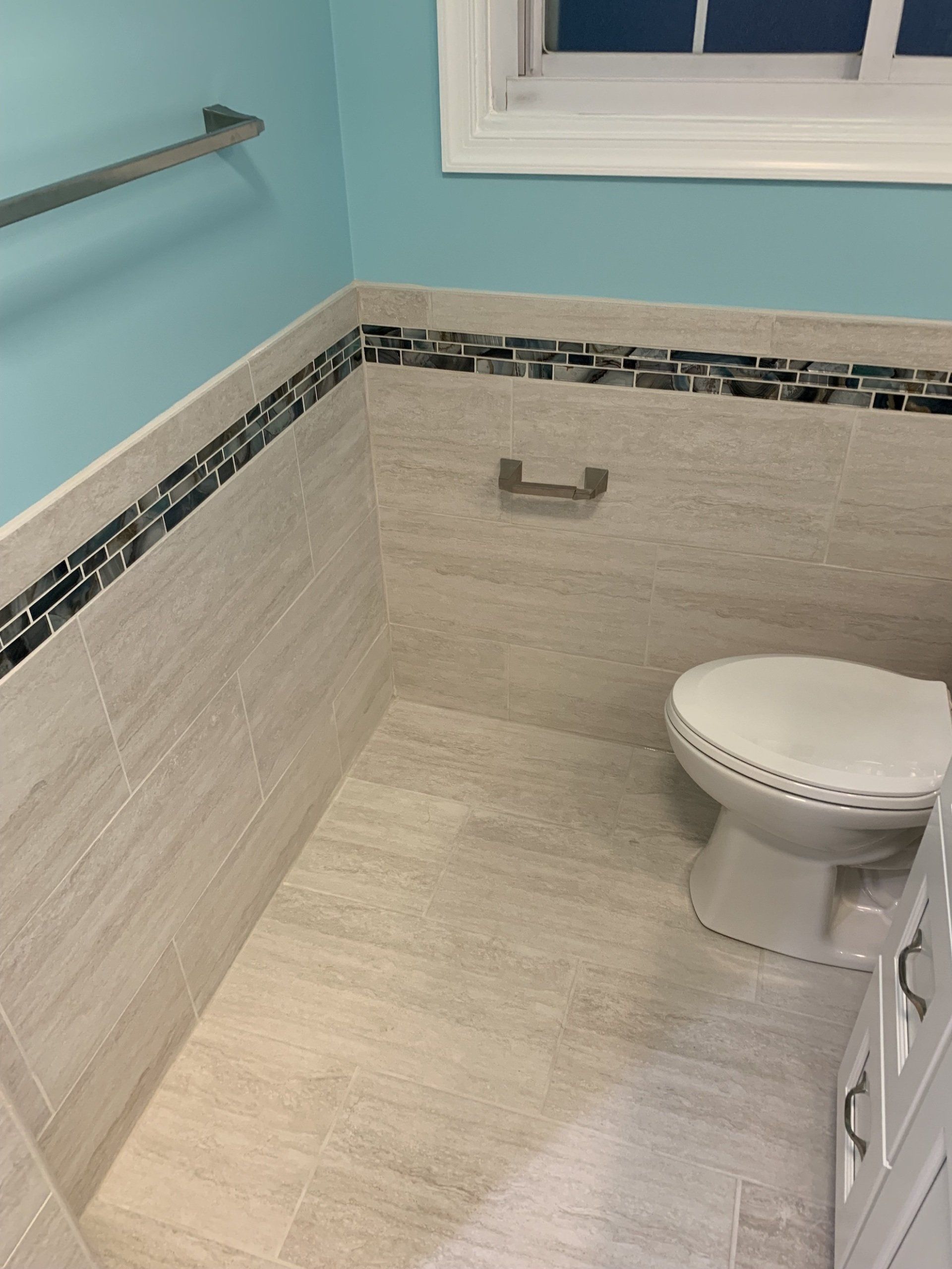 bathroom renovation adding accent tile around bathroom walls