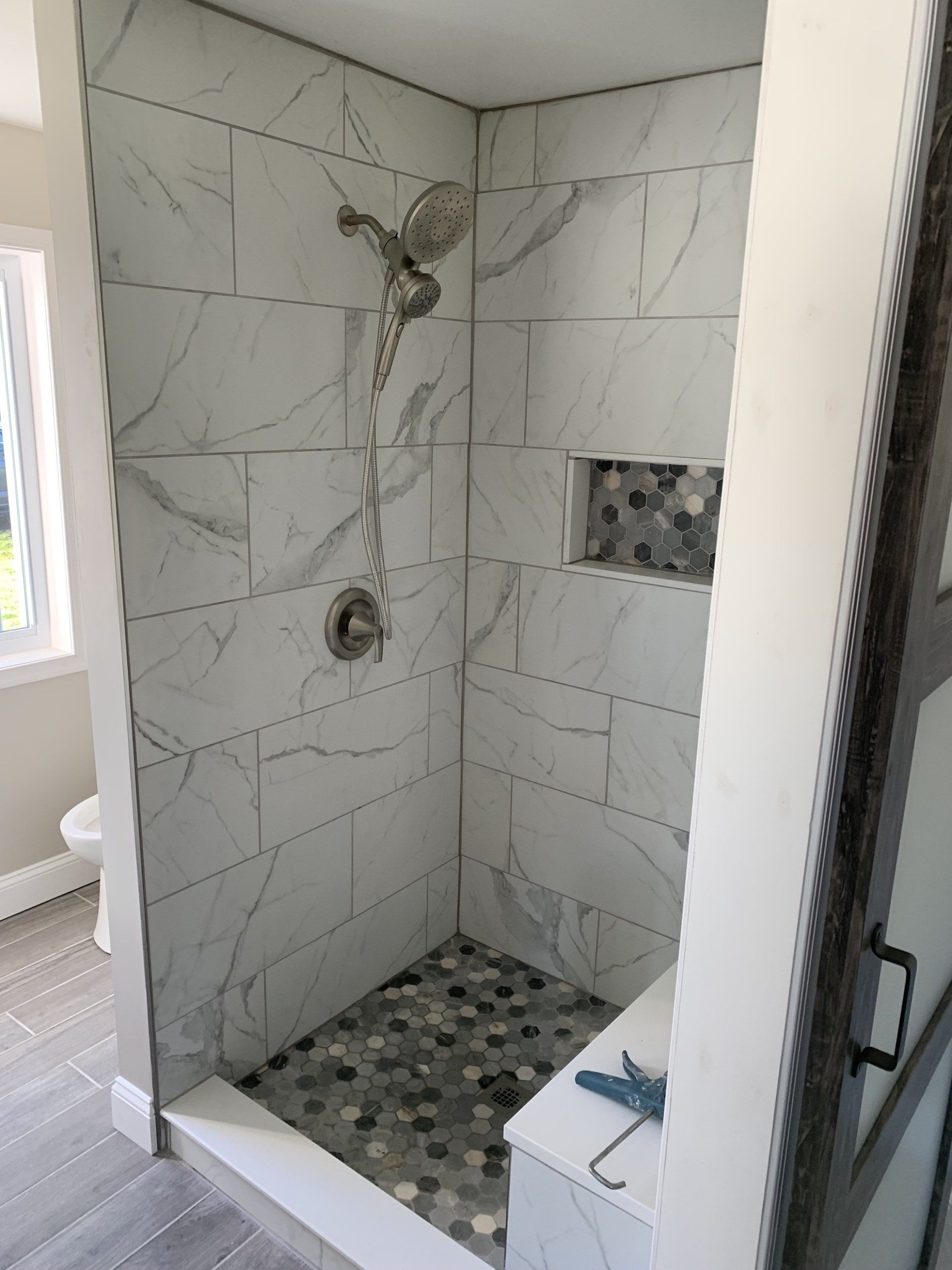 shower renovation adding tile on walls and floor