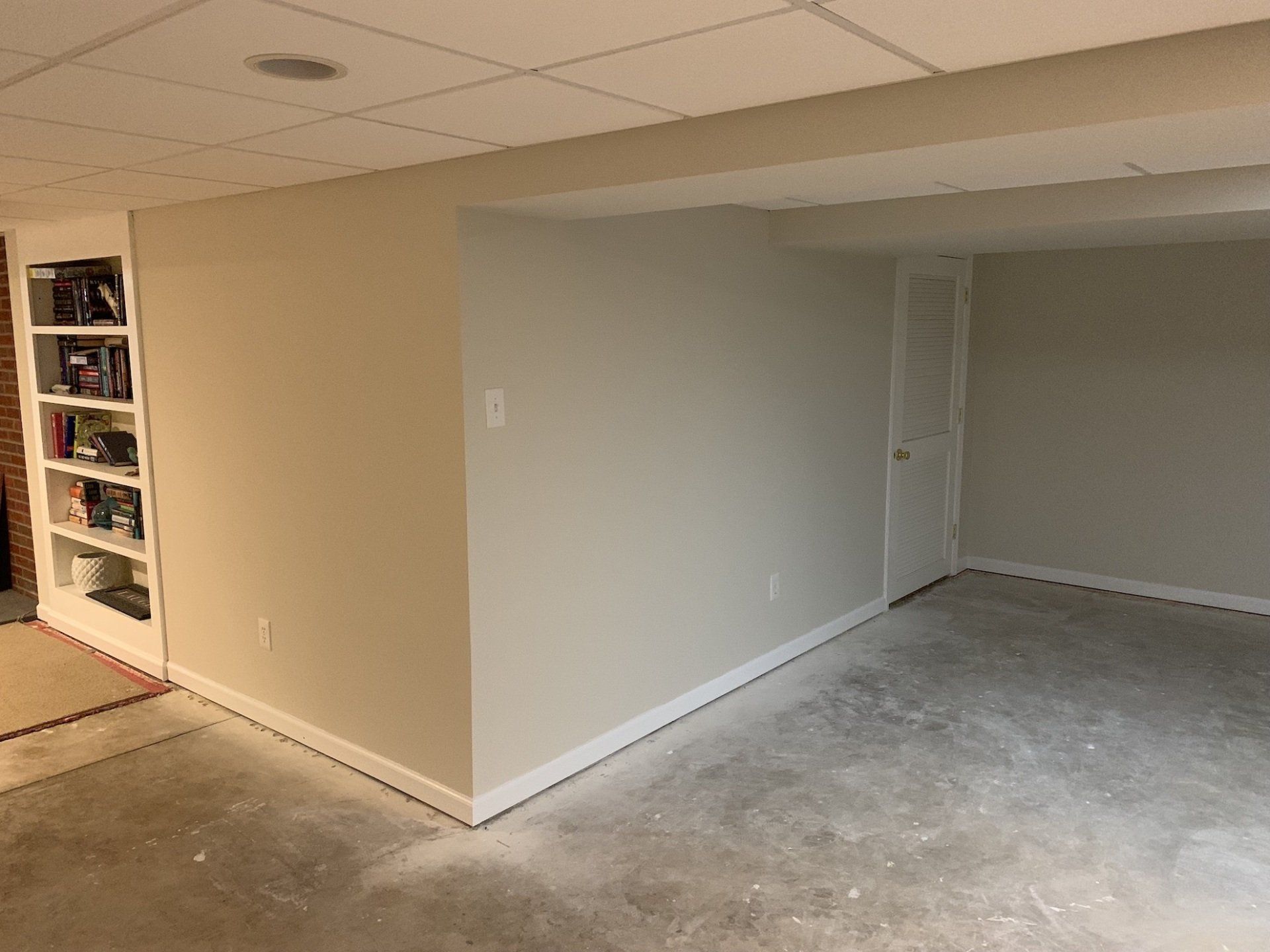 Basement remodel in progress with painted walls