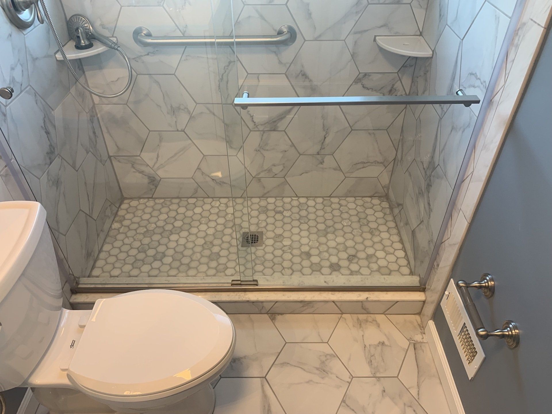 newly remodeled bathroom with brown tile flooring
