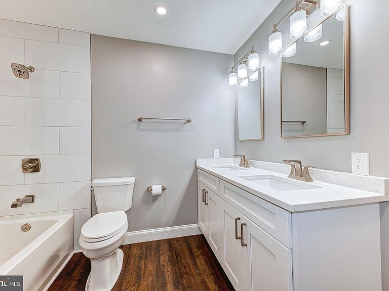 newly remodeled bathroom with new cabinets and flooring
