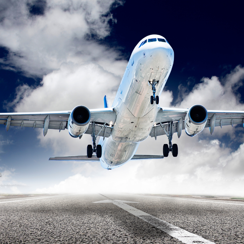 A large passenger jet is taking off from an airport runway