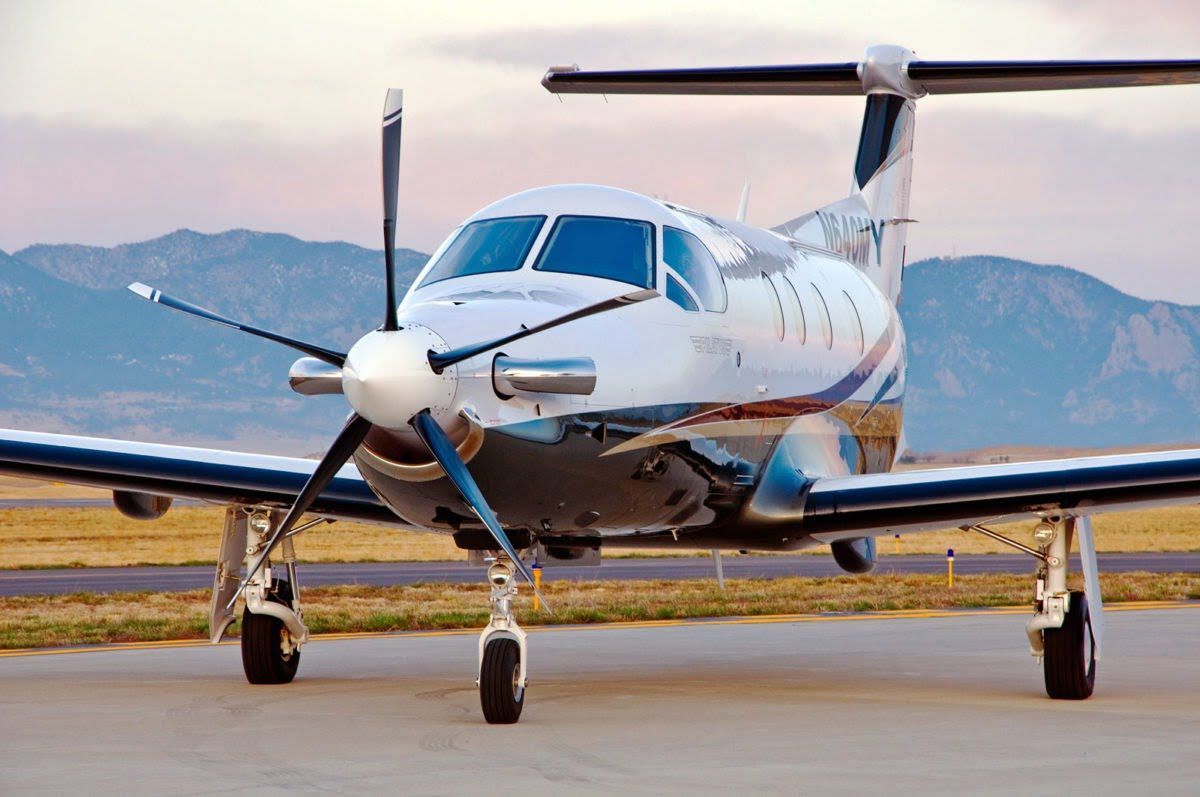 A small propeller plane is parked on the runway.