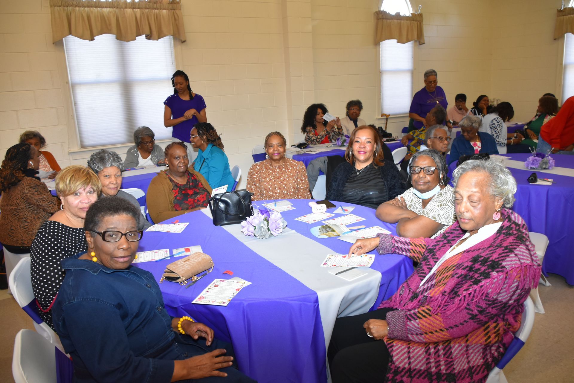 A group of people are sitting at tables in a room.