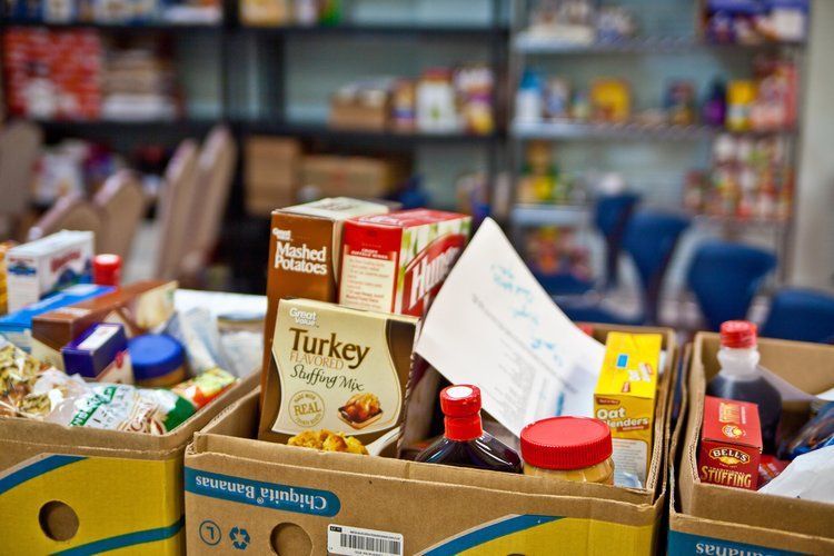 A bunch of boxes filled with food in a pantry.