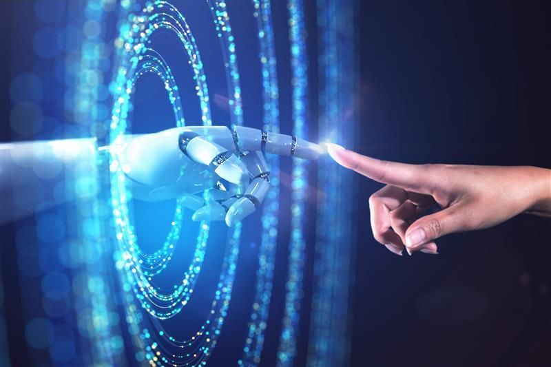 Robot hand touching a human finger, with a blue digital interface in the background.