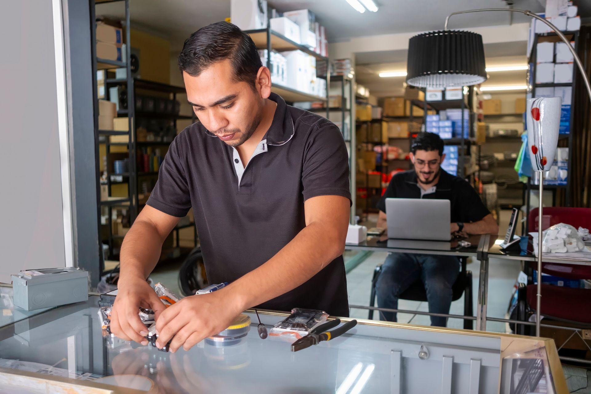 Pile of various electronic components, including capacitors, resistors, and transistors, on a white surface.