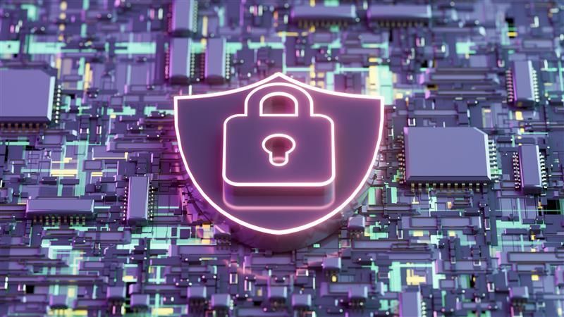 Glowing neon security shield with padlock over computer circuit board.