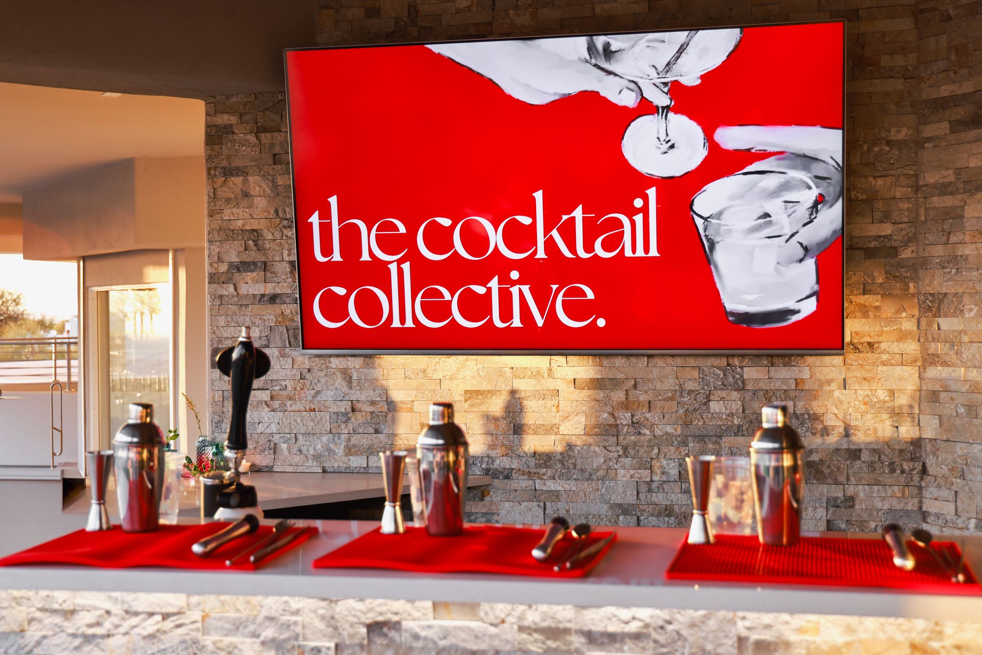 A bar with a sign that says the cocktail collective