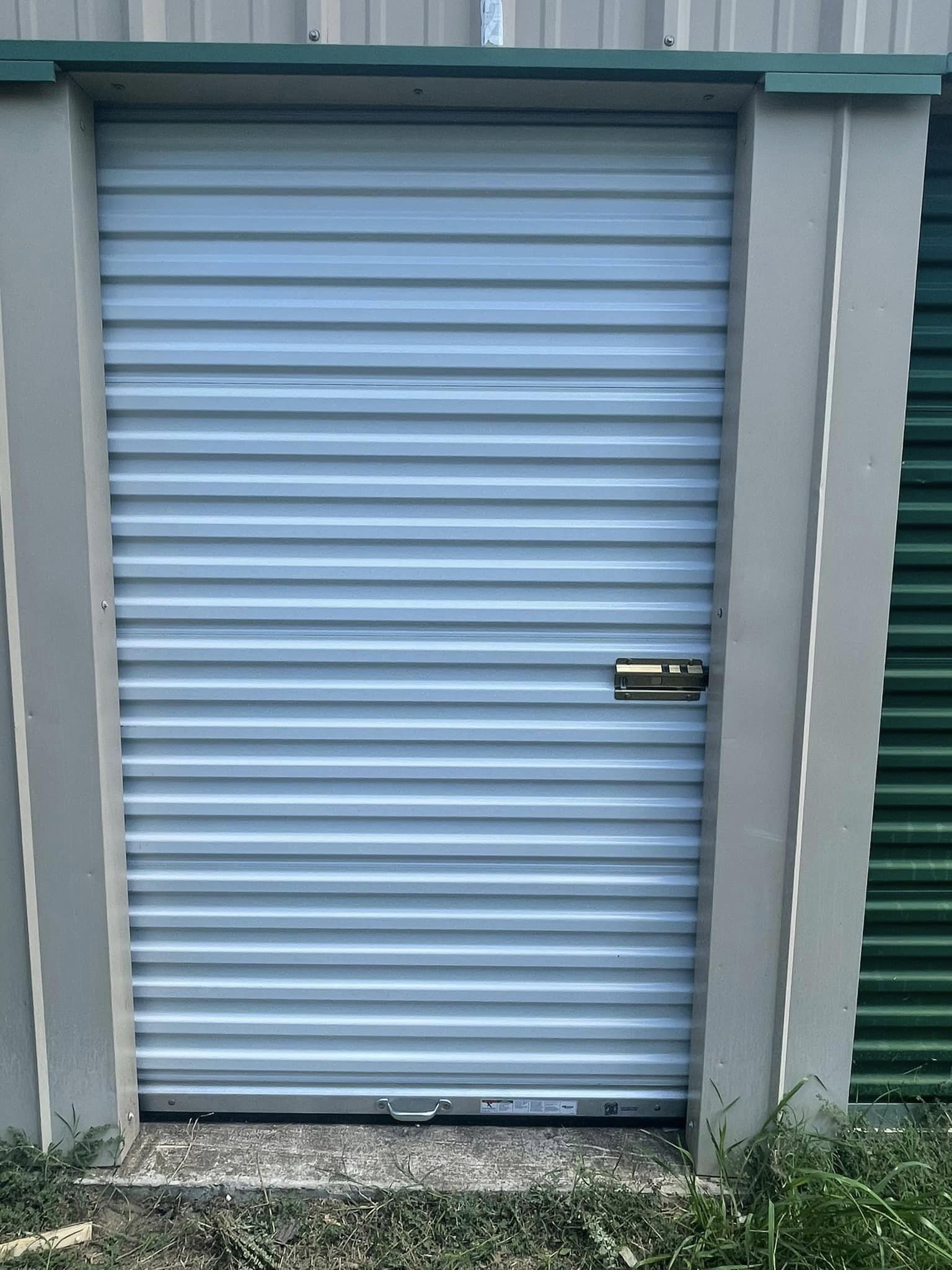 Light Blue Garage Door With Lock — Okmulgee, OK — Kingdom Door Company