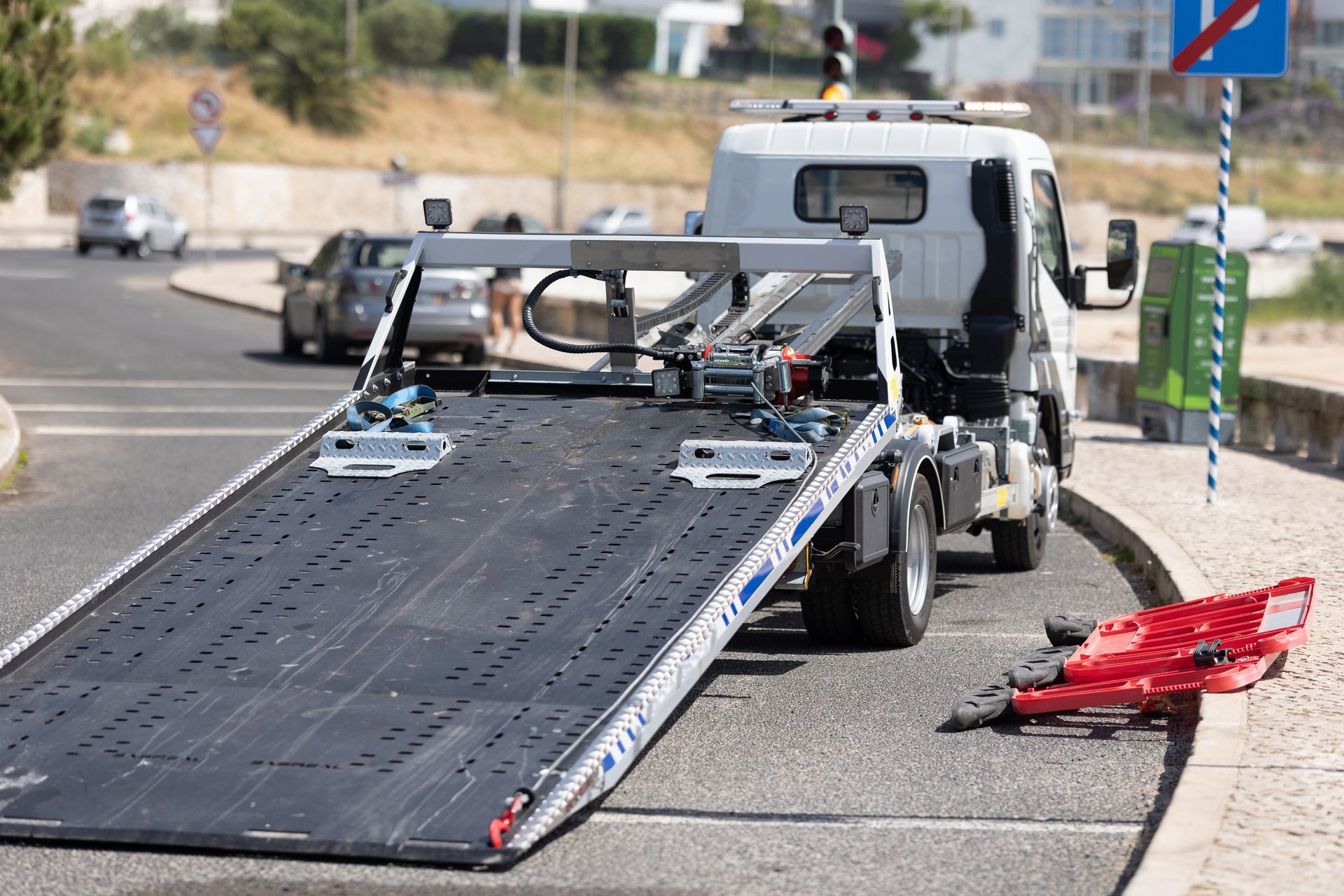 A tow truck is parked on the side of the road.