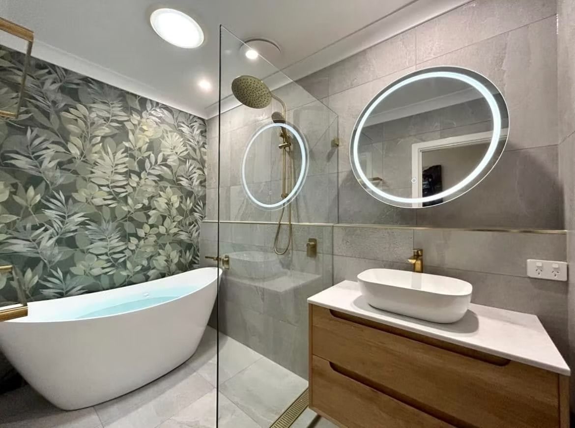 A bathroom with a bathtub , sink , mirror and walk in shower.