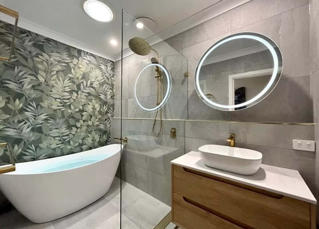 A bathroom with a bathtub , sink , and shower.