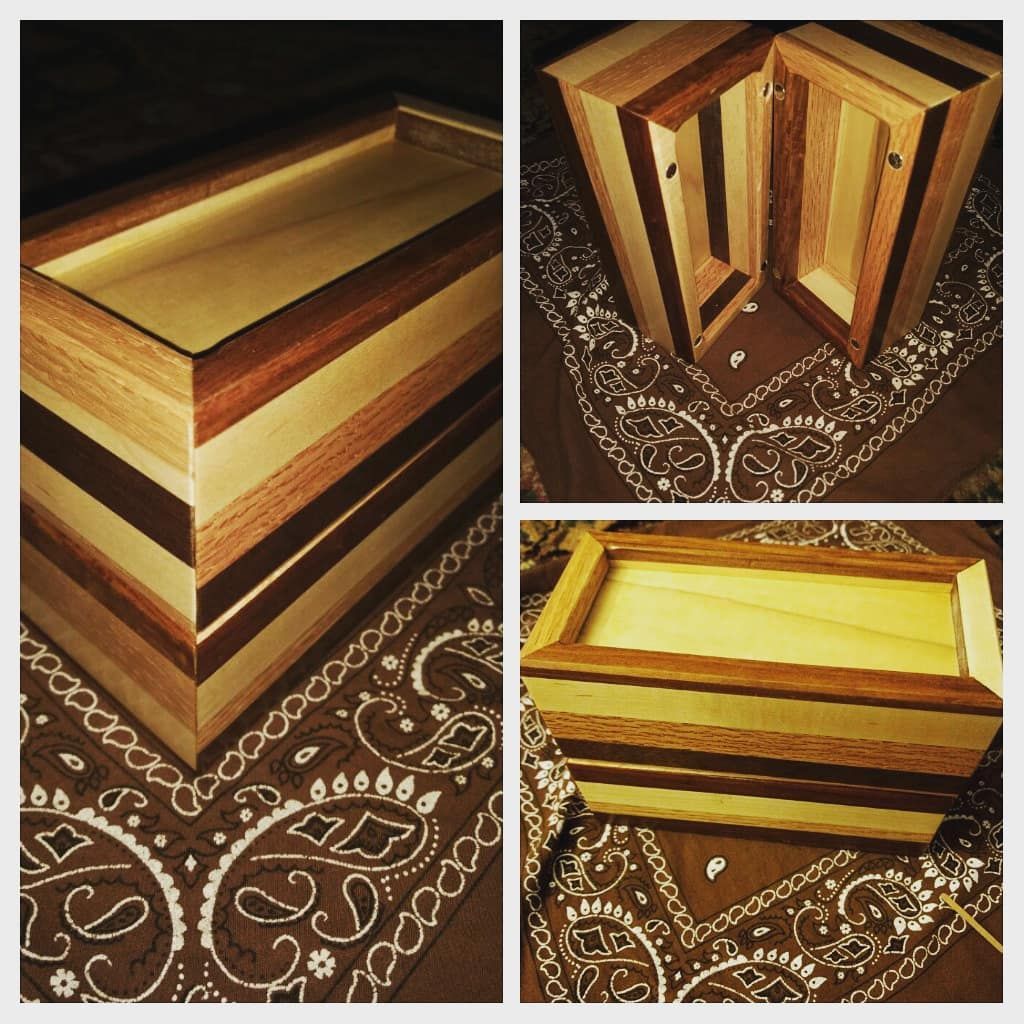 Three views of a multi-toned wooden box, with hinged lid, set on a paisley patterned cloth.