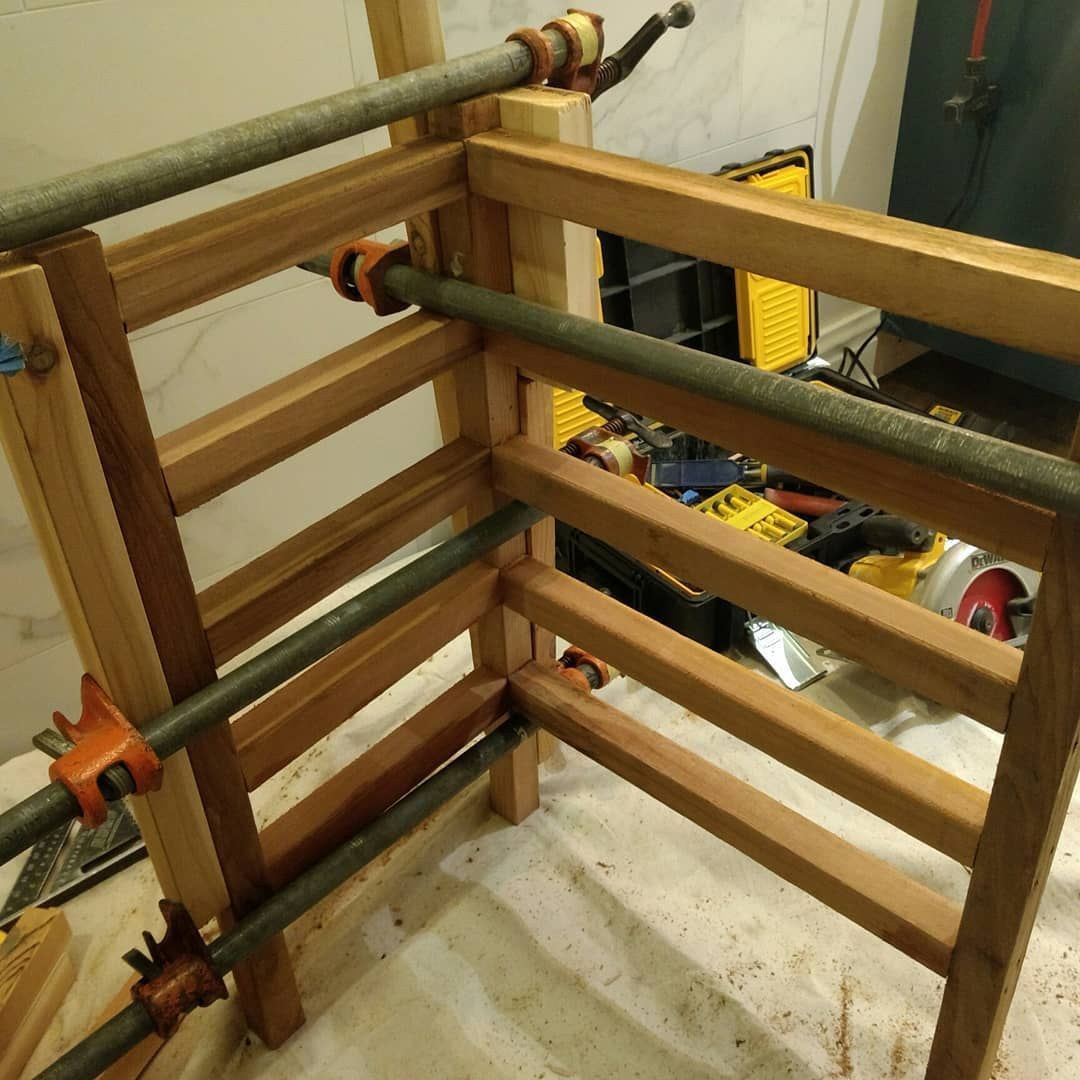 Wooden frame clamped together for assembly.