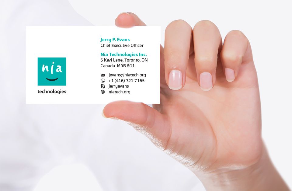 Hand holding Nia Technologies business card