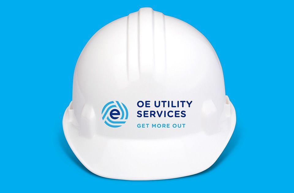 OE Utility Services logo on safety helmet