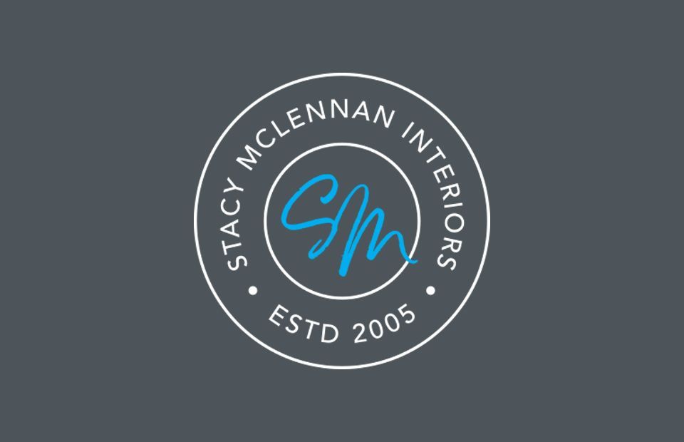 Stacy McLennan Interiors logo as a badge on a dark background