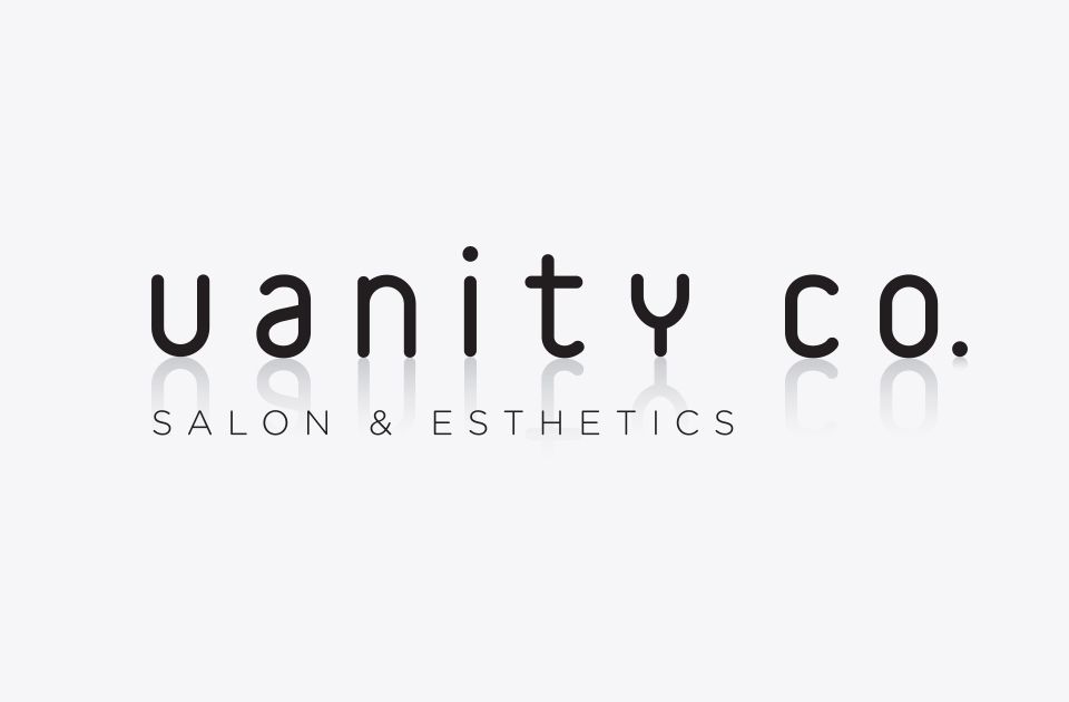 A black and white logo for vanity co. salon and aesthetics