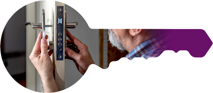 a man is fixing a door lock with a key