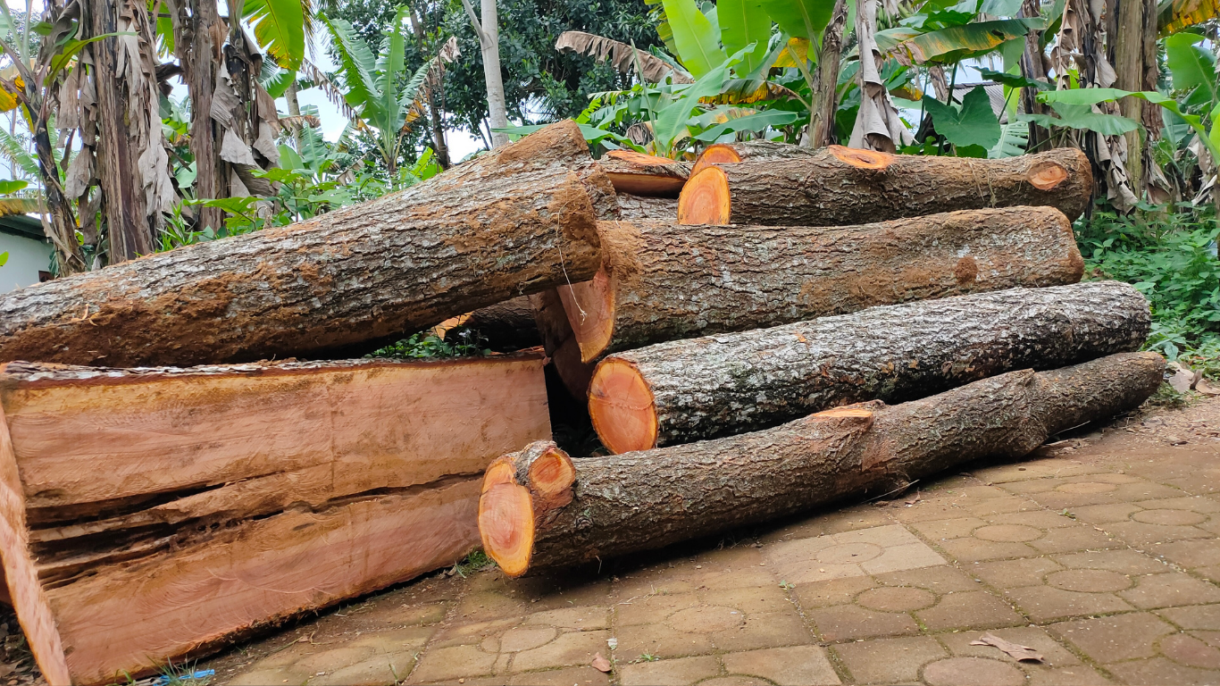 A pile of logs sitting on top of a brick floor.